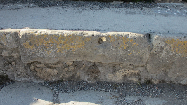 This hole was used for tying your horse to, while you were in the shop